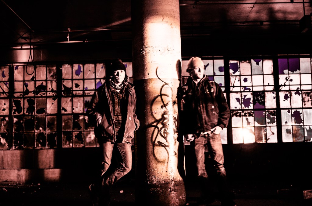 Explorers in a strange land, stumble upon whispers, flashes of people rushing by. The bustle of laborers, the steady, almost ringing hum of the machinery pumping out a plethora of industrial consumer goods. The smell of industry and burning coal fill the corridors, the giant ventilation fans struggling to exhaust the fumes of production. The images fade. The explorers now see only the ruins of the past, quiet - constant, yet crumbling slowly under the progression time. Time we created - they think. The first twinkle of dawn emerges through the east windows. The explorers take one last solemn look around the factory before heading back to their ropes in the elevator shaft where they made the slow ascent back to the roof to make their discreet exit.